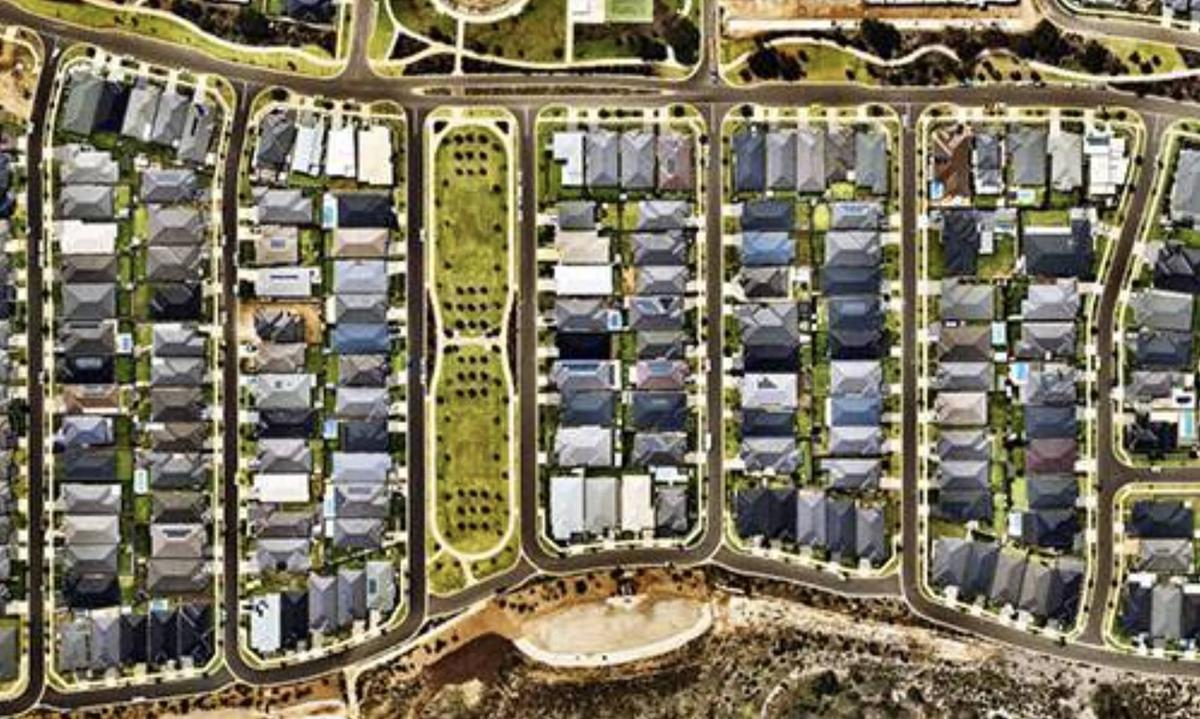 Aerial view of a newly developed residential subdivision with roads, lots, and landscaping